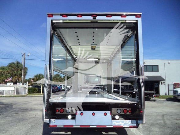 Kenworth T280 truck rear cargo area showing empty box with open ramp tailgate and reflective surface.