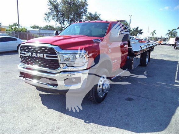 Ram 5500 tow truck from the front-left view showing heavy-duty grille and flatbed.