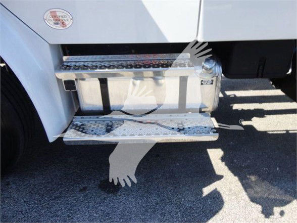 Freightliner M2 106 side step and fuel tank visible under cab with textured aluminum steps and chrome fuel cap.