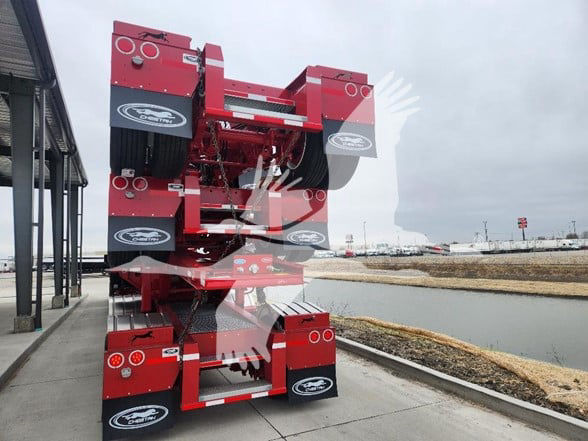Container trailer back-end with red chassis stacked on top of each other; multiple circular taillights and black mud flaps with white logos visible.