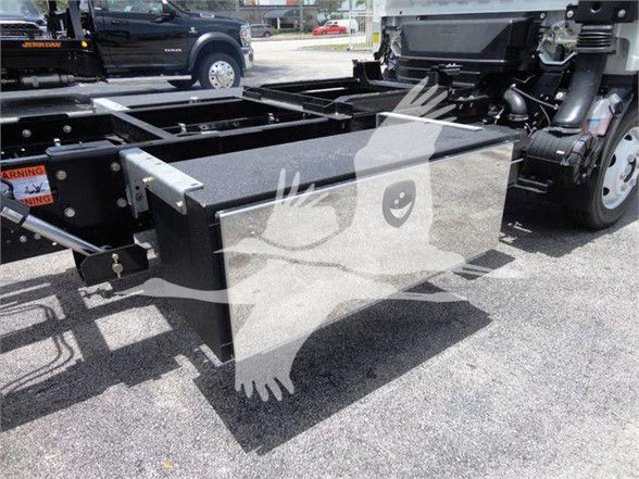 Isuzu NRR truck chassis with a large rectangular black toolbox mounted between the frame rails.