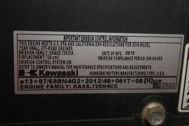 Label showing emission information for a Kawasaki engine: 'THIS ENGINE MEETS U.S. EPA...' with ' emissions compliance period: 500 hours' and 'ENGINE FAMILY: KAXS.726N4CC', plus 'Kawasaki' logo.