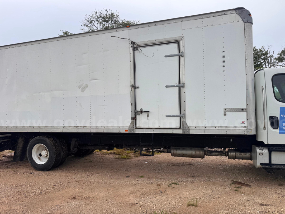 Side view of a 2016 Freightliner M2 106 box truck with a rear service door and a white cab.