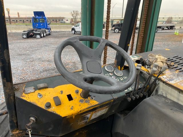 Kesmac F5000 forklift operator cockpit with steering wheel and control levers in view.
