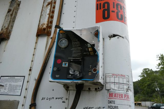 Great Dane trailer exterior showing fuel/air generator panel and control box with labels, fuel cap, and warning stickers.