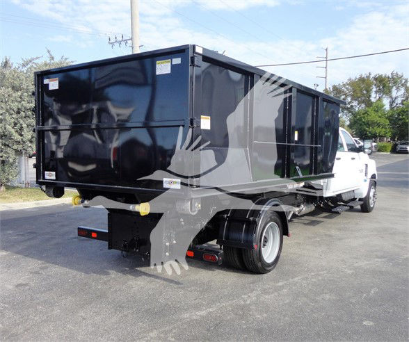 Chevrolet Silverado 5500HD dump truck rear side view with black dump body and white cab.