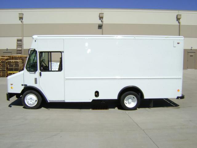 Box truck body showing plain white Freightliner MT45 step van with cab in front and minimal markings.