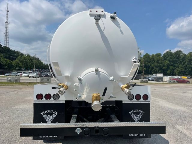 Rear view of a 2015 Freightliner M2 septic sewer service truck with a large white cylindrical tank, two side valves, and Phoenix mudflaps.