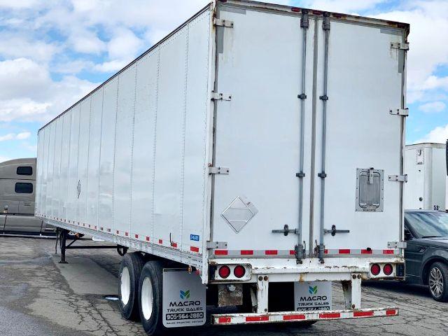 2009 Stoughton dry van trailer with dual rear doors and tandem axles.