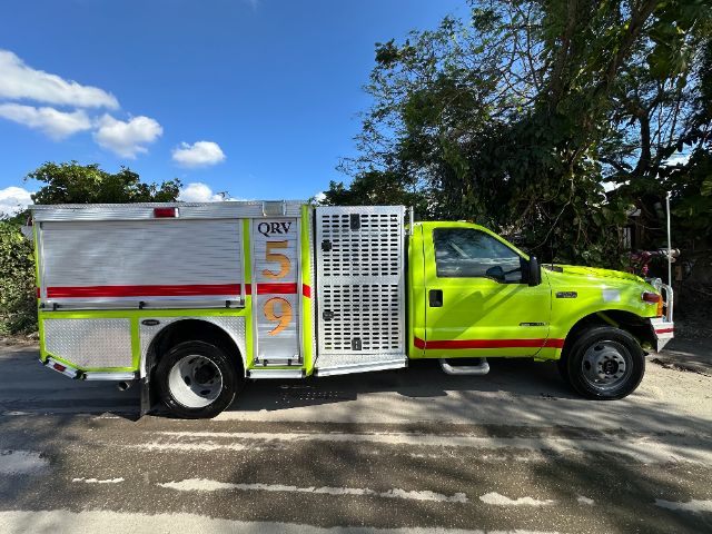 Fire truck body with bright yellow-green cab and aluminum compartments, QRV 59 side lettering, side intake grille, black tires