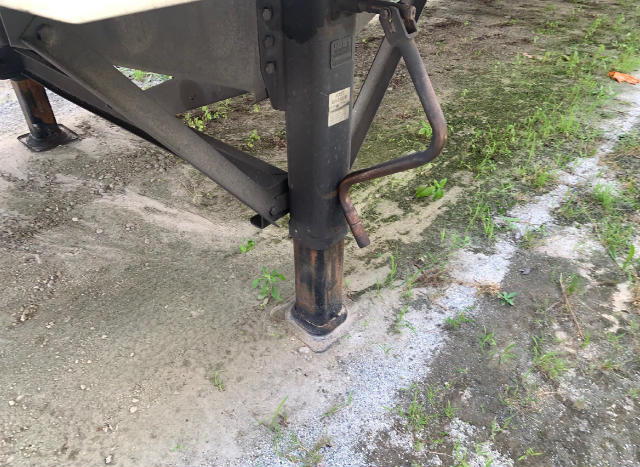Trailer hitch leg and support jack of Vanguard VXP trailer with visible leg and stabilizer pad in ground.