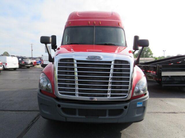 Freightliner Cascadia Evolution front view showing large chrome grille, red cab, and black bumper.
