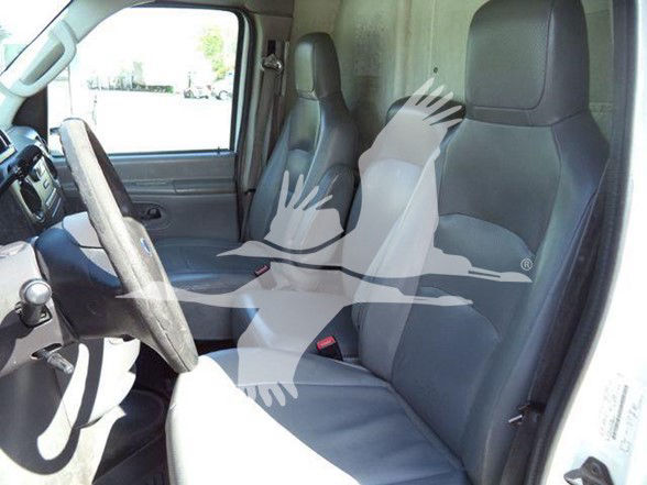 Ford E-450 van interior showing driver and passenger seats and steering wheel.