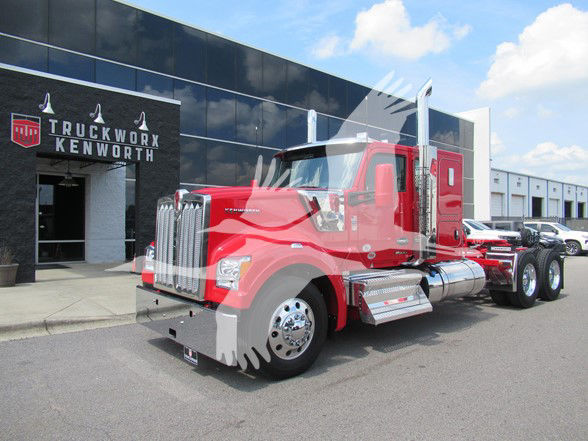 Kenworth W990 truck in red outside a dealership.