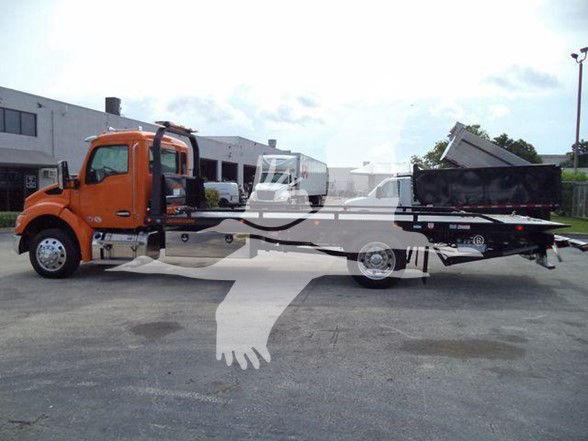 Kenworth T280 tow truck in orange cab and flatbed with hydraulic arm, side view showing truck and bed.