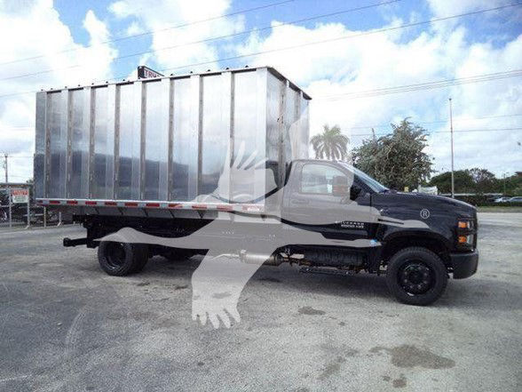 Truck with large metal cargo bed, black cab, Silverado 6500HD chassis, side view showing rear metal dump body.