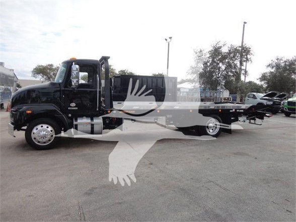 2023 Mack MD6 tow truck in a lot with a long flatbed; VIN 1M2MDBAA5PS007254; stock J07254; category Tow; type Trucks; condition New.