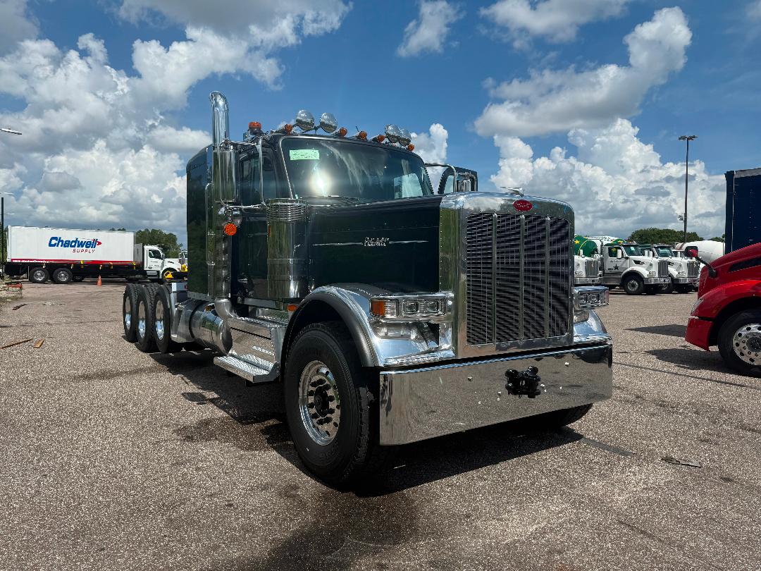 Peterbilt heavy haul truck in dark green with chrome grille and large bumper, top-mounted lights, dual bunk with big air filter, 6x4 rear, trailer-ready.