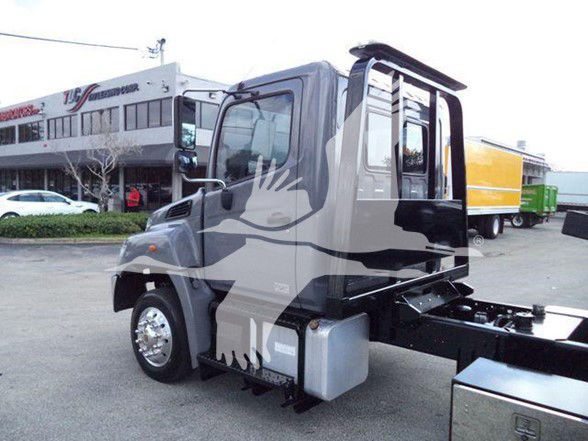 2014 Hino 258ALP tow truck cab and chassis showing side view with fuel tank and step, in a dealership lot.