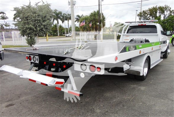 Ram 5500 HD tow truck flatbed rear view showing tow equipment and rear bumper.