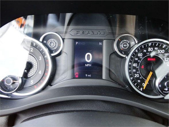Ram dashboard showing digital gear indicator with PRND, '0 MPH' and odometer reading '9 mi' and circular gauges on left and right.