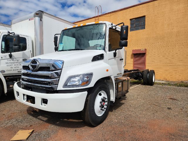 White 2025 Hino L6 cab and chassis truck parked on lot showing front grille and side view, with chrome bumper and dual rear wheels absent.