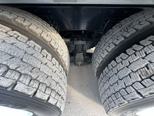 Freightliner M2 rear dual wheels showing drivetrain components and suspension undercarriage.