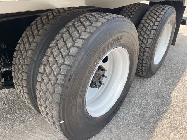Dual rear tires on a Freightliner M2 truck showing tread detail and white rims.