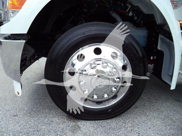 Kenworth T280 wheel and front fender showing chrome hubcap and tire, with white body panel and wheel well.
