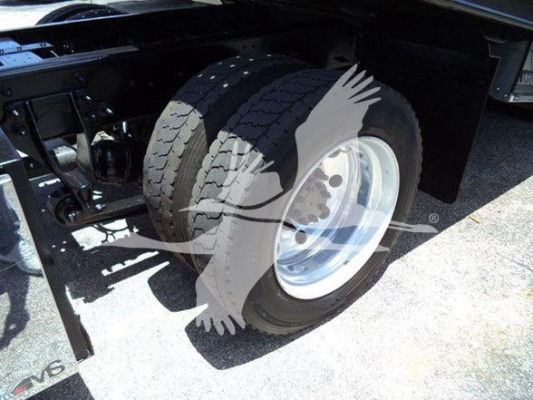 MV-series wheel and dual rear tires on a 2022 International MV truck showing polished rims and black chassis.
