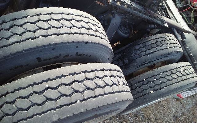 Truck tires and rear axle area of a Freightliner conventional tractor with dual rear tires.