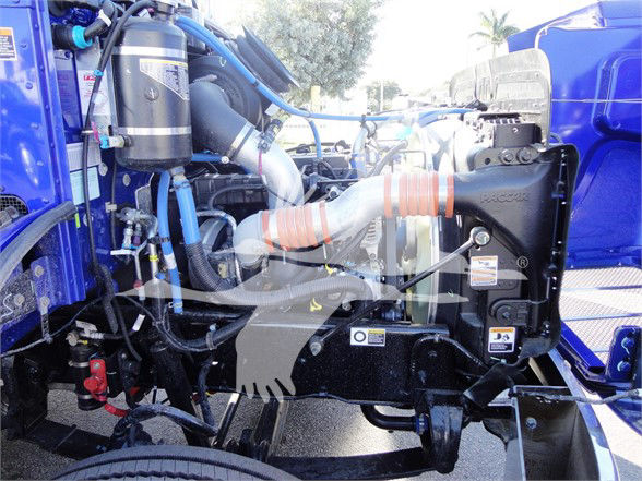Peterbilt 337 engine bay showing coolant hoses, air intake, and surrounding components.