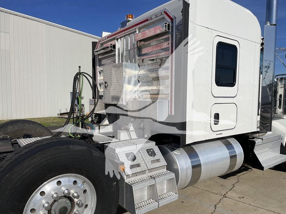 Kenworth T800 truck side cab and fuel tanks with chrome steps and polished metal components visible.