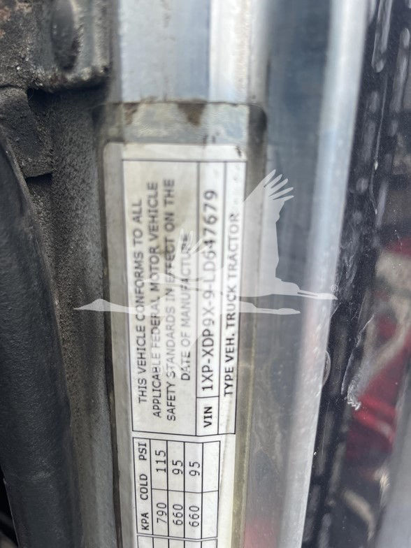 Label on door frame showing vehicle conformity sticker with VIN 1XDP9X9LD647679 and weight/pressure data.