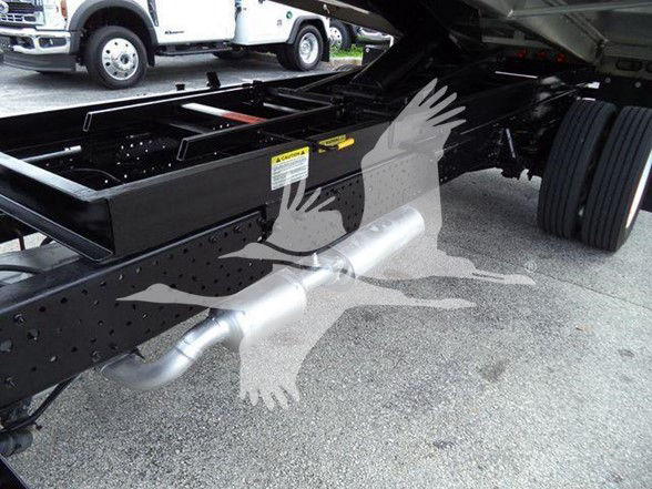 Isuzu NPR HD truck chassis showing undercarriage, frame rails, exhaust pipe, and rear tires. Visible sticker on frame.