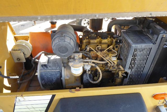 Allmand Night Lite Pro engine bay showing diesel engine with radiator, belts, hoses, and air intake.