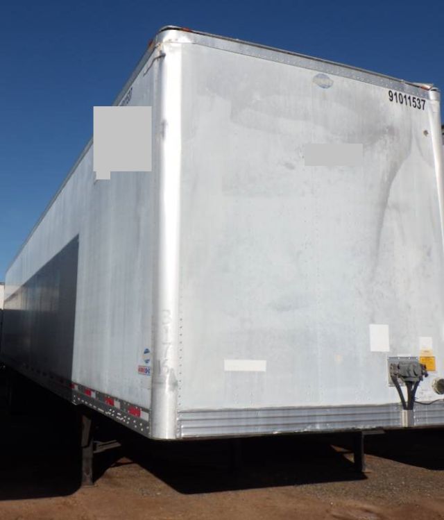 Utility 4000DX composite trailer exterior showing rear and side panels with registration number 91011537.