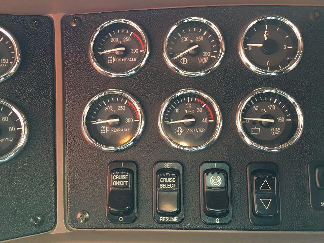 Peterbilt 578 instrument cluster panel showing multiple gauges and control switches.