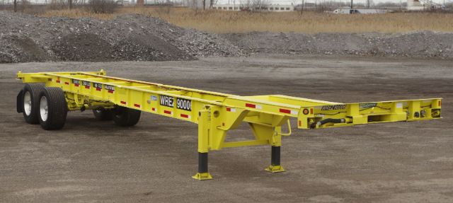 Intermodal heavy duty trailer/chassis on level ground, yellow with WRE 9000 labeling and supporting legs extended.