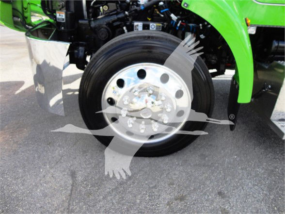 Front wheel and green fender of a Peterbilt truck with stock numbers and category text overlayed.