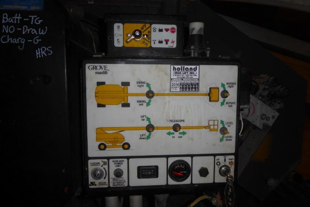 Grove T60 boom lift control panel with labeled levers and gauges, including lift/level indicators and safety switch, in-service condition.