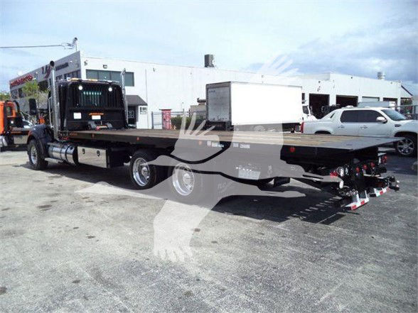 Kenworth T880 heavy haul tractor with flatbed trailer, side view, stock number KWT880HD15T in a lot.