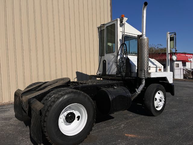 Kalmar Ottawa 30 yard truck chassis with white cab, large exhaust stack, dual rear wheels, and black frame.