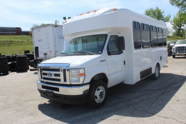 Ford E-450 shuttle bus side and front view with white body and tinted windows.