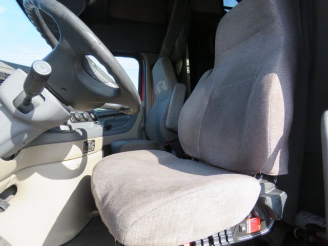 Cab interior of a 2016 Freightliner Cascadia Evolution truck showing steering wheel and driver's seat.