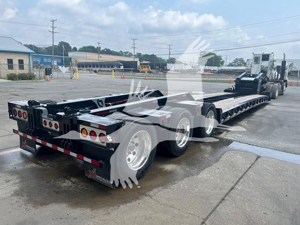 XL Specialized Xl110Hdgs18 Guardian 55-Ton lowboy trailer showing multiple axles and rear lighting with watermark.