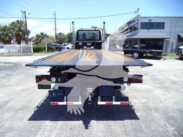 Kenworth T880 flatbed truck rear view showing wooden deck and taillights.