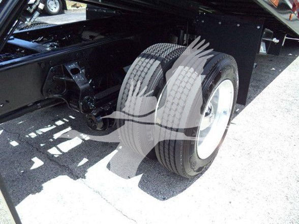 Truck rear dual wheels and chassis undercarriage showing right-side dual tires and suspension components.