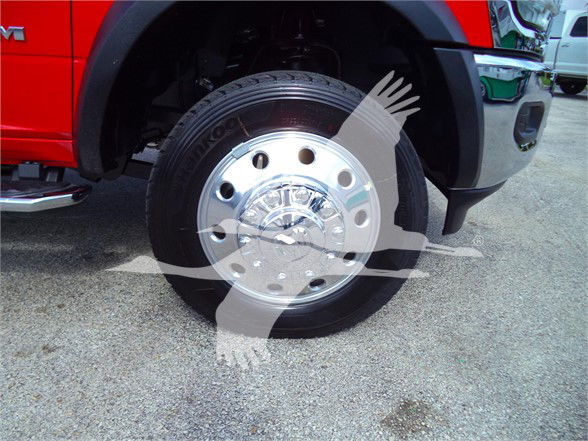 Ram 5500 SLT front wheel showing polished chrome wheel with Nokian tire and red truck body in background.