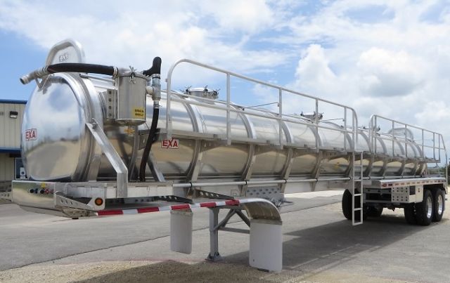 EXA aluminum vacuum tank trailer showing exterior cylinder with platforms along top and dual rear axles.